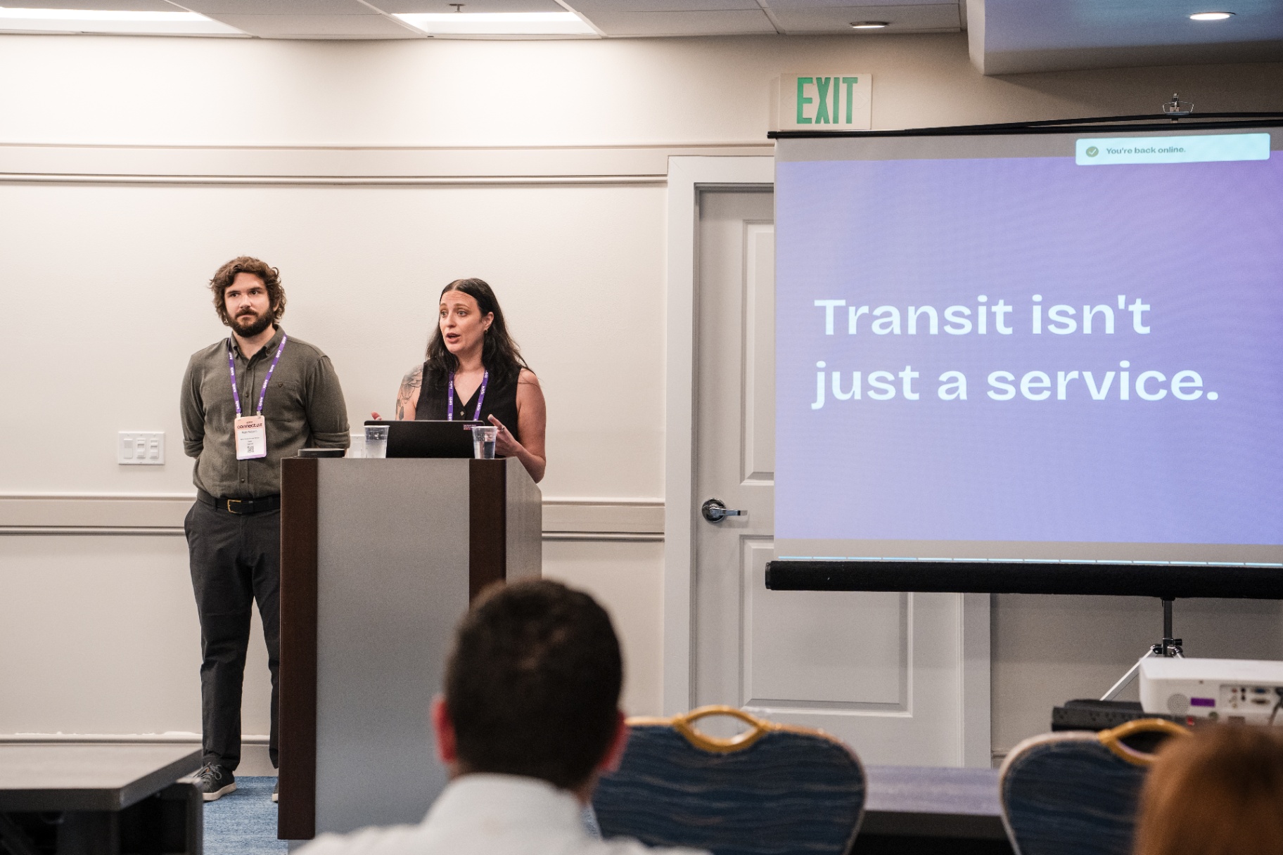 Co-presenters at the podium with Transit isn't just a service slide