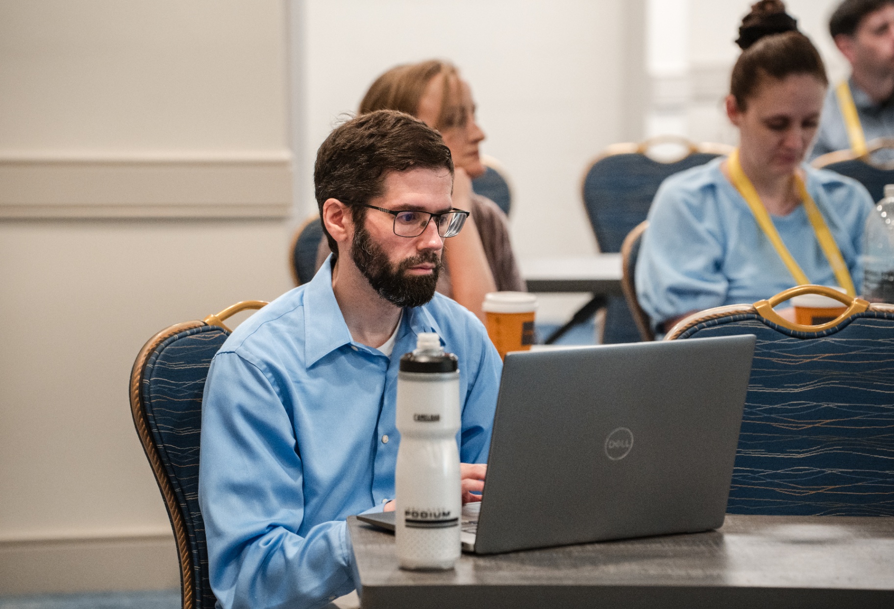 Attendee working on a laptop during a Day 1 breakout session