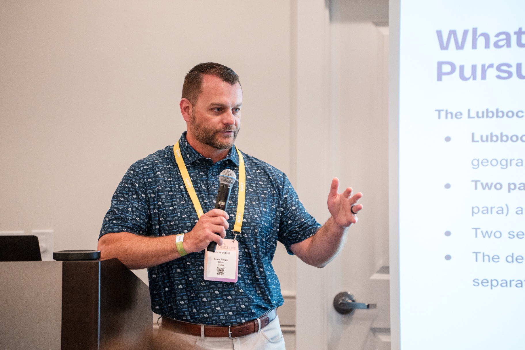 Chris Mandrell speaking with one hand extended during the Day 2 session