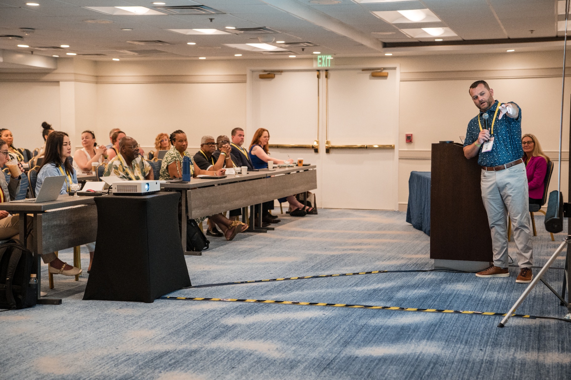 Chris Mandrell pointing toward the audience during the Day 2 talk