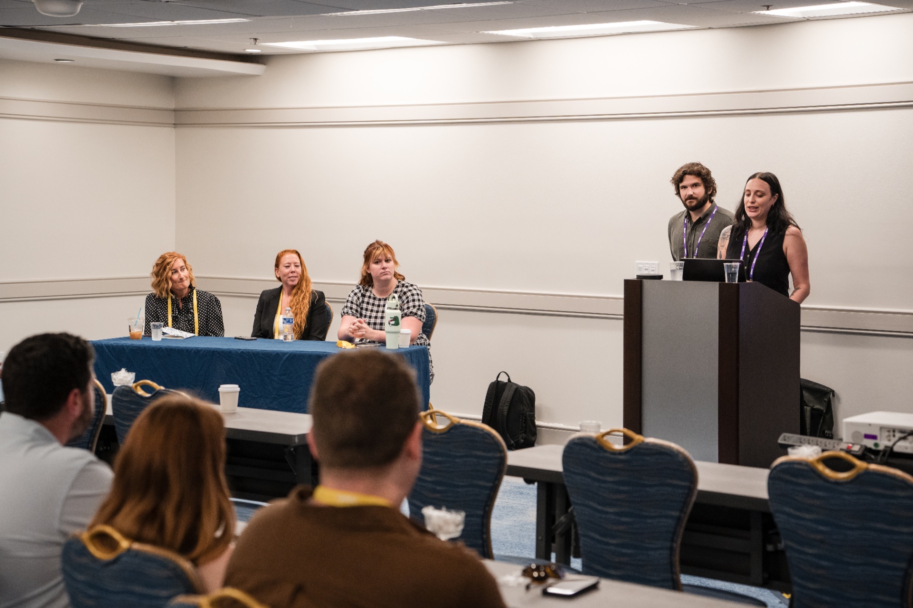 Wide view of the breakout room with panel and podium speakers