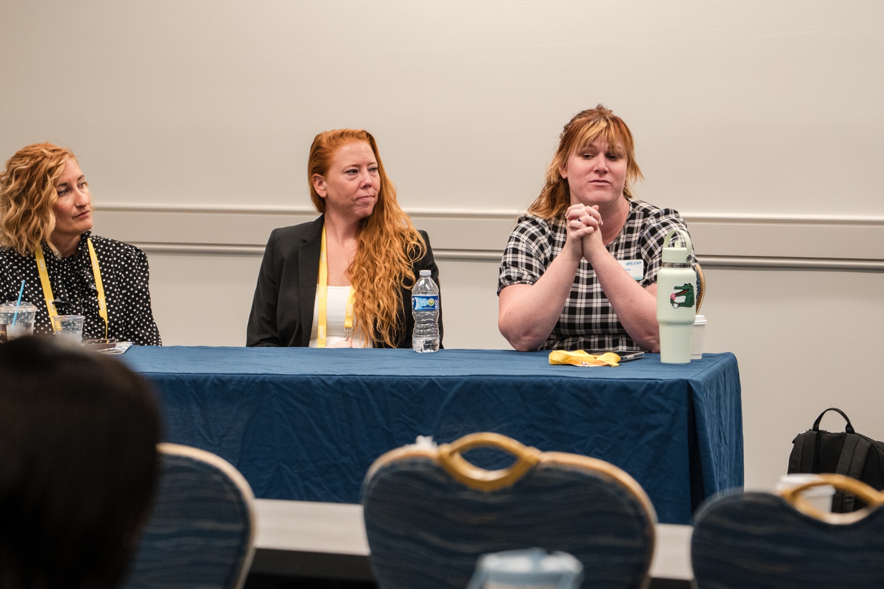 Three panelists listening at the front of a Day 1 breakout room