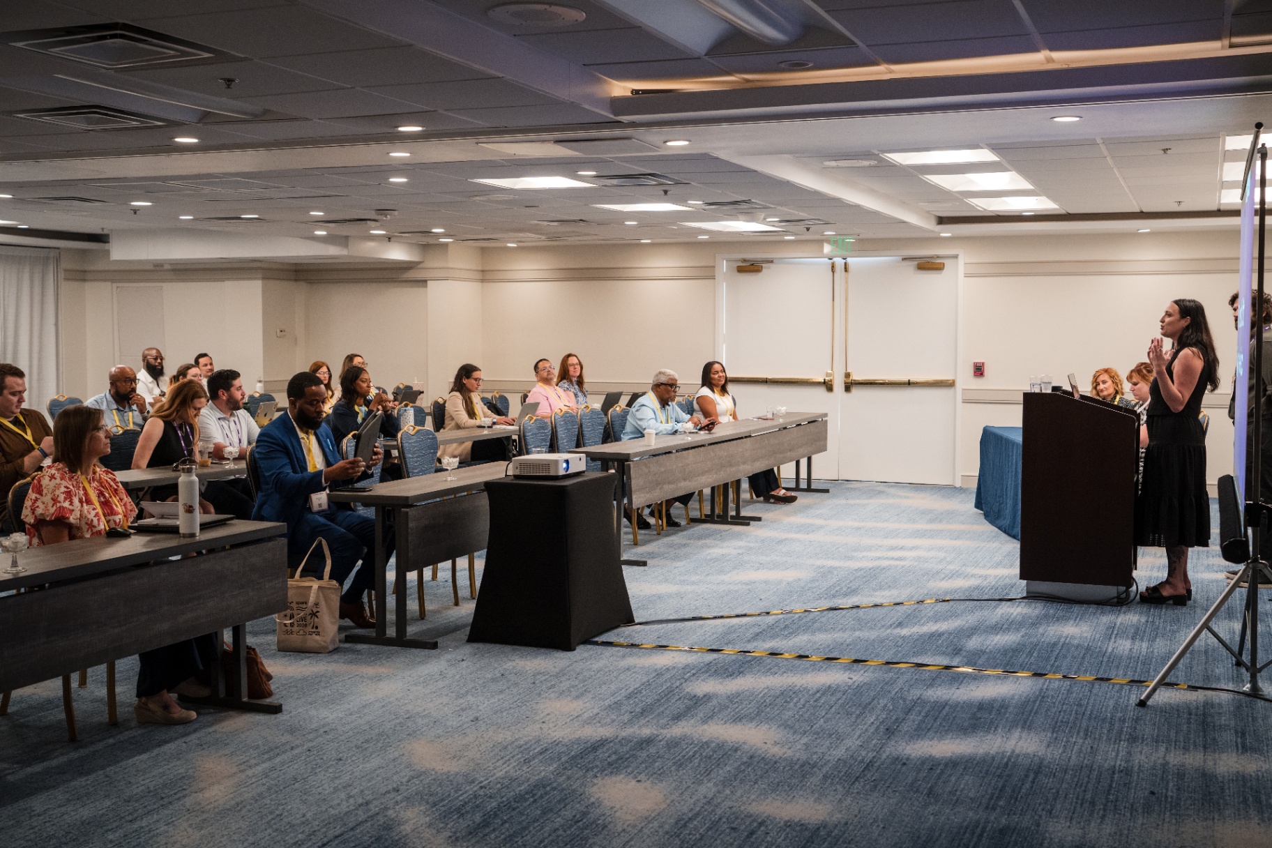 Speaker addressing the audience from the podium in a Day 1 breakout