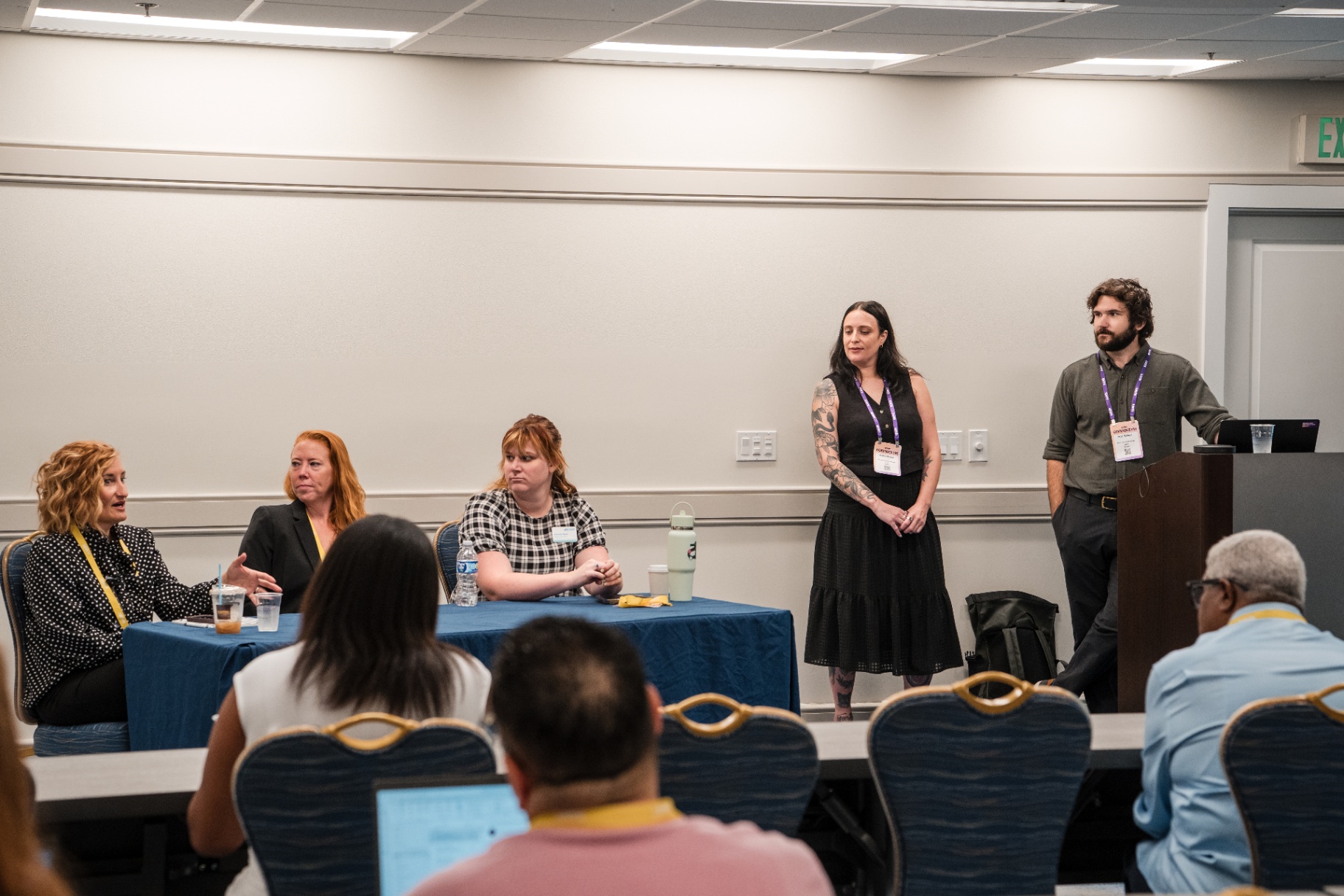 Panelists and presenters taking questions at the front of the room