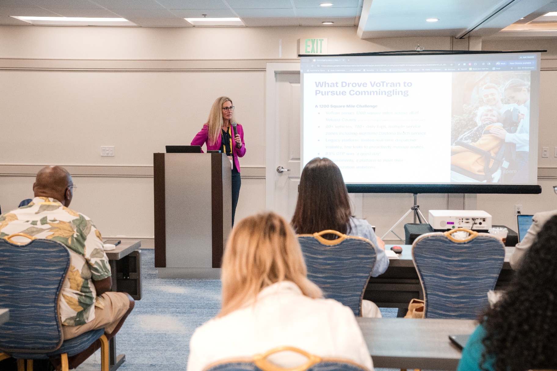 Wide room view of the VoTran commingling presentation with attendees facing the screen