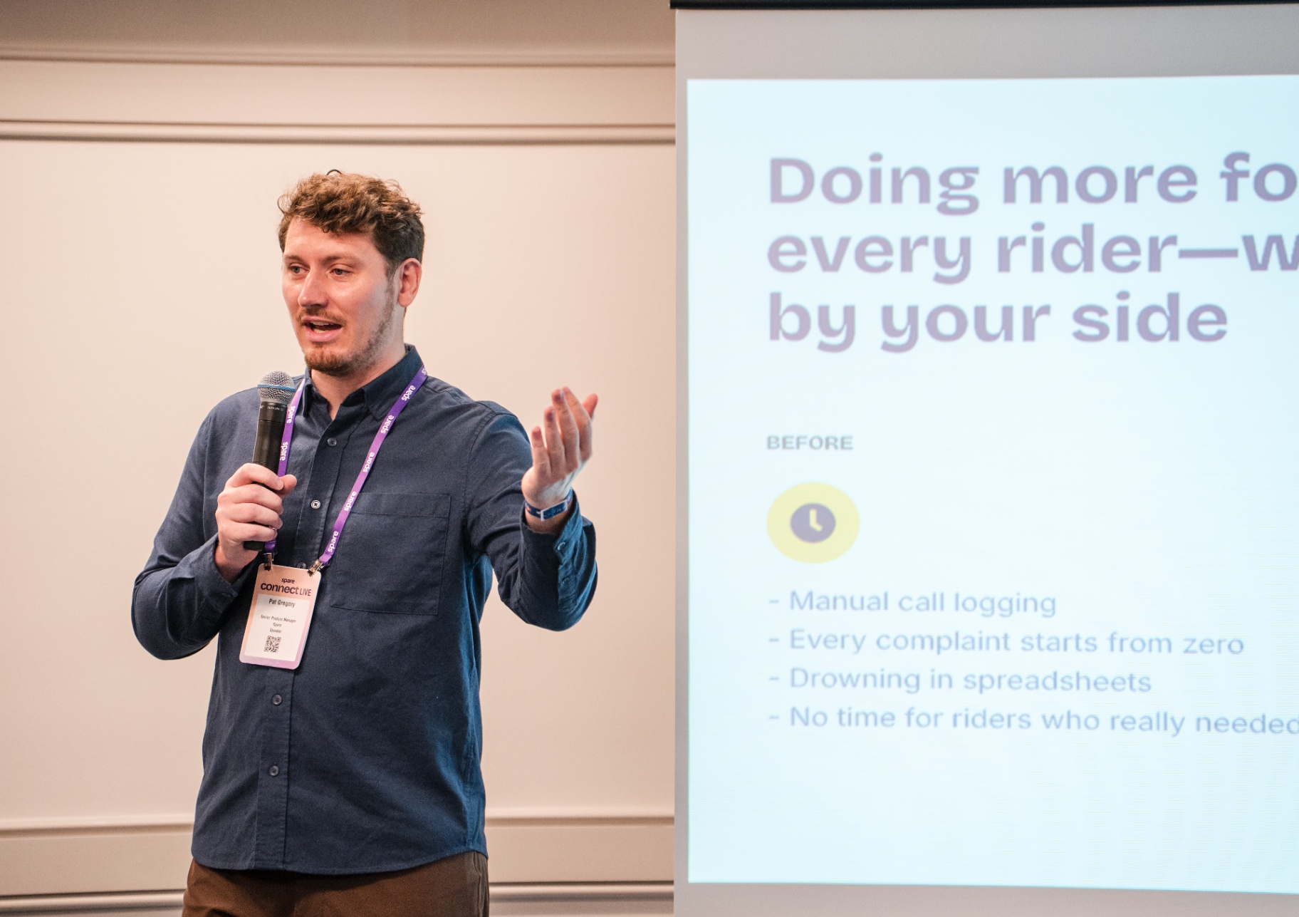 Close-up of Pat Ongroy speaking beside the AI presentation slide