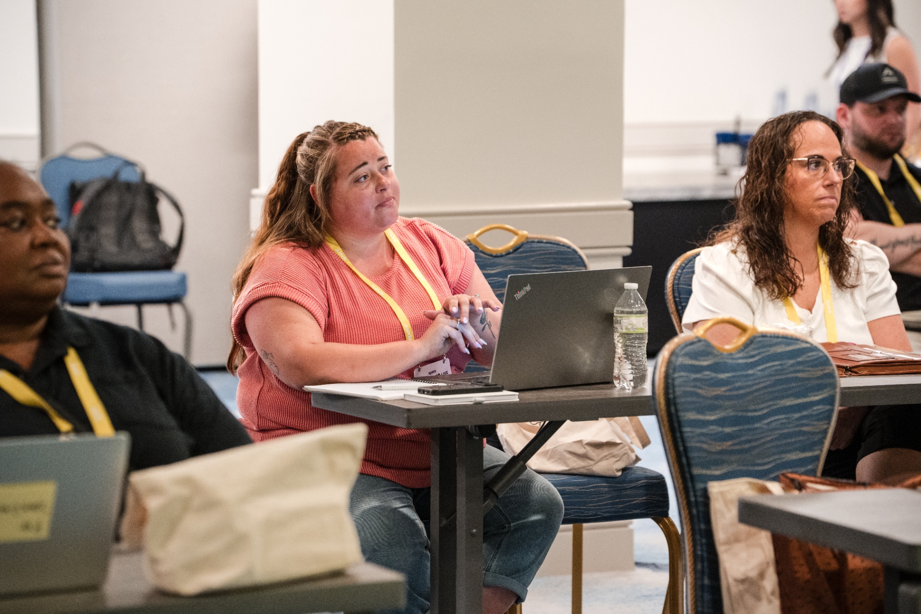 Attendees seated with laptops during a Day 1 session