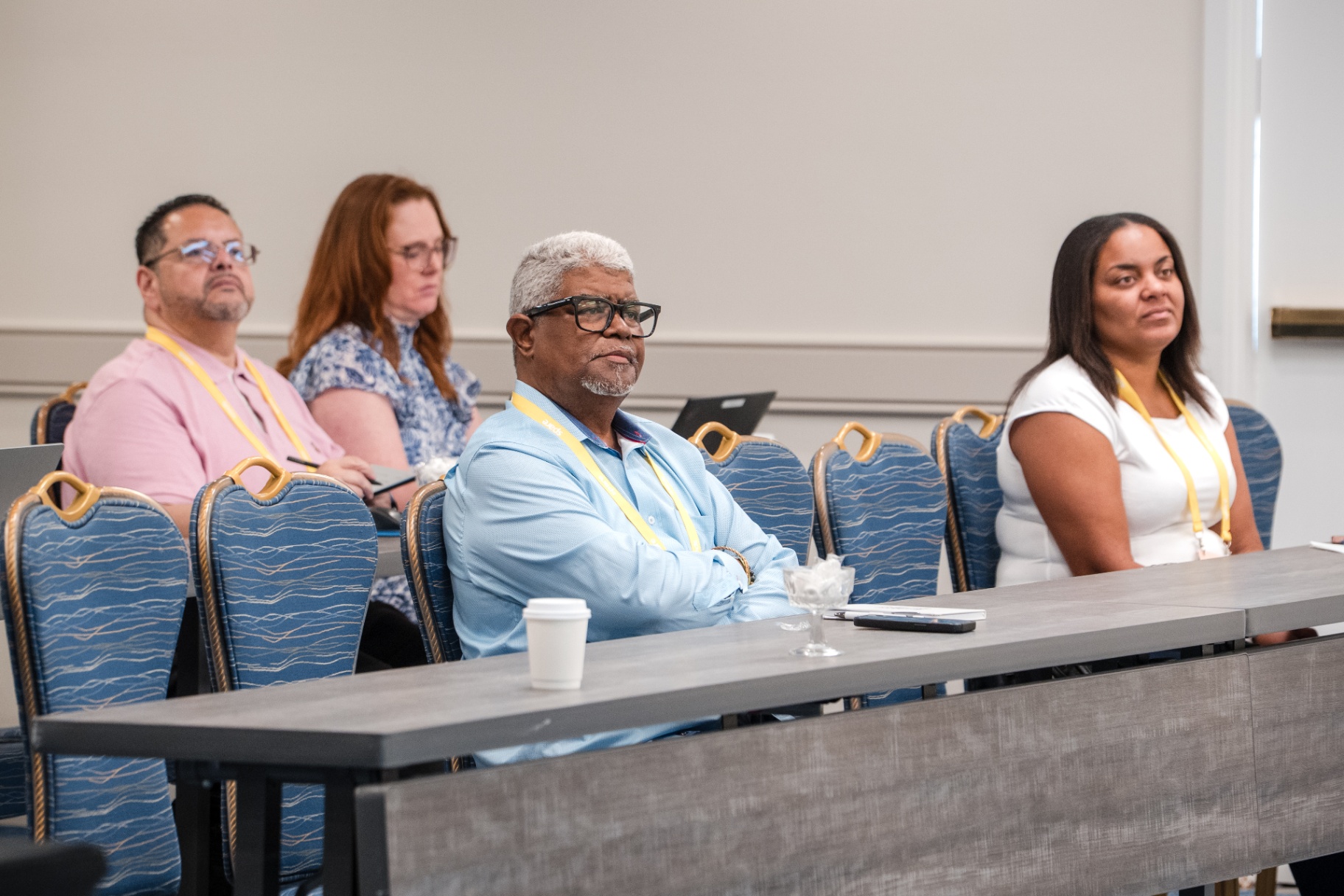 Front-row attendees focused on a breakout presentation