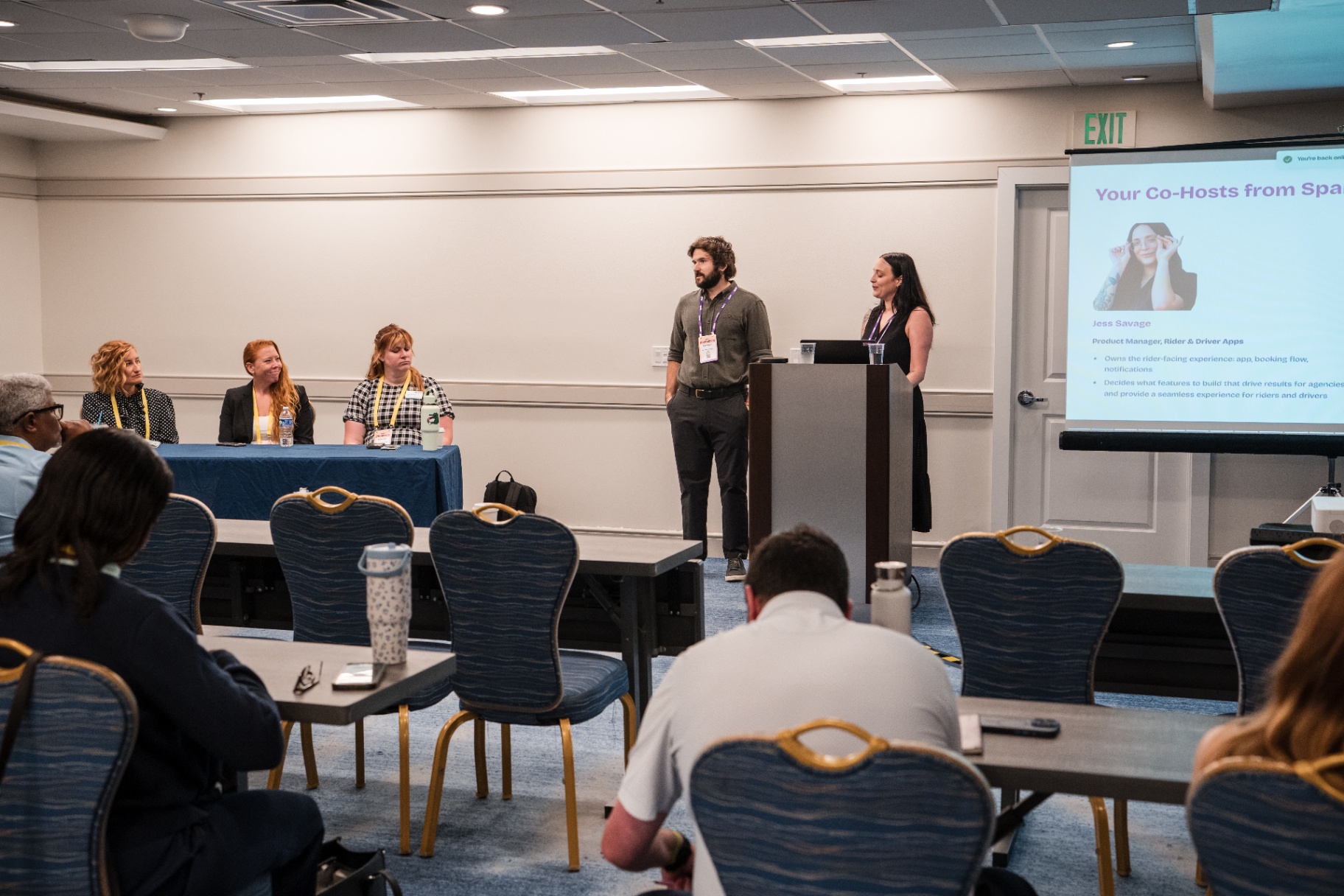 Two speakers at the podium during a Day 1 panel session