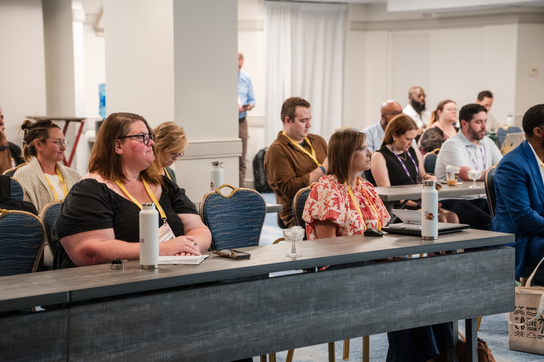 Close view of attendees seated and listening during a Day 1 session